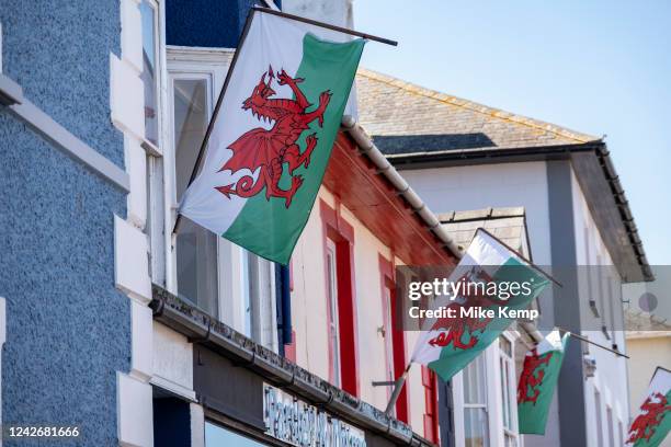 Welsh flags hanging outside homes on 11th August 2022 in Aberaeron, Pembrokeshire, Wales, United Kingdom.