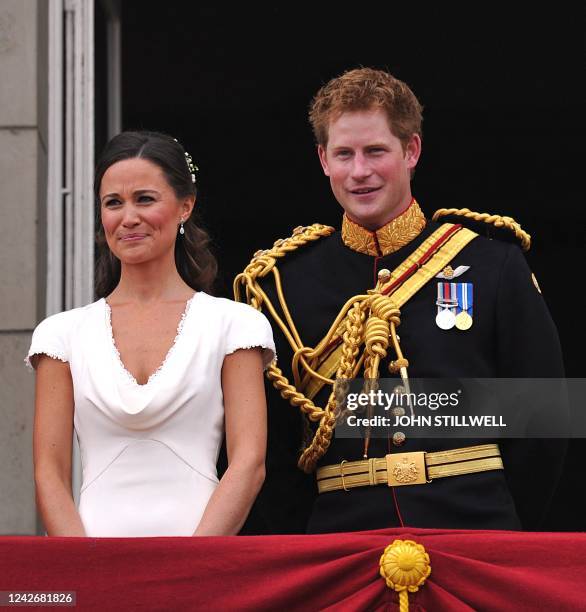 Philippa Middleton and Britain's Prince Harry appear on the balcony of Buckingham Palace in London on April 29 following the wedding of Britain's...