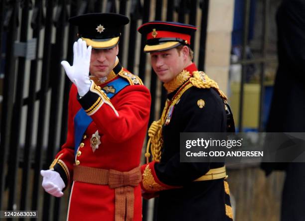 Britain's Prince William waves as he arrives with his brother Prince Harry at the West Door of Westminster Abbey for his wedding, in London on April...