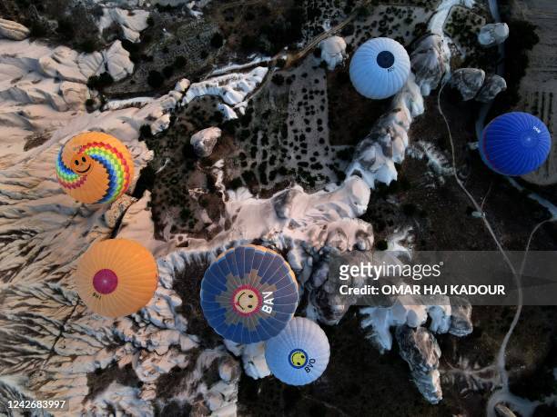 This aerial view shows hot air balloons launching in Goreme Historical National Park, east of Nevesehir in the province of the same name in central...
