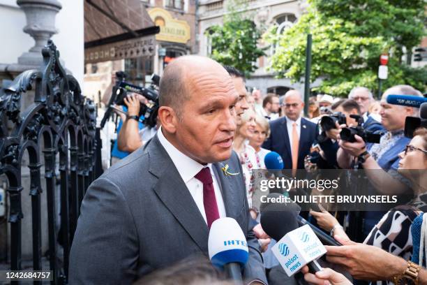 Brussels city mayor Philippe Close talks to the press as the Manneken Pis statue in the city center of Brussels wears a Ukrainian flag on Wednesday...