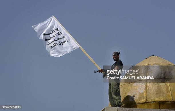 Holding a white flag with an Islamic inscription written on it, a Palestinian militant from the Al-Aqsa Martyr's Brigade, an armed off shoot of the...