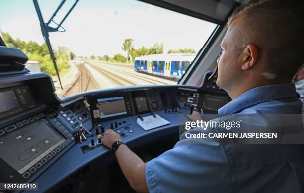 Train driver Alexander Kluge drives a train powered entirely by hydrogen in Bremervoerde, on August 24, 2022. - A fleet of 14 trains provided by...