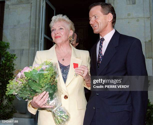 La chanteuse et comédienne Line Renaud montre les insignes d'Officier dans l'Ordre national de la Légion d'honneur que vient de lui remettre le...