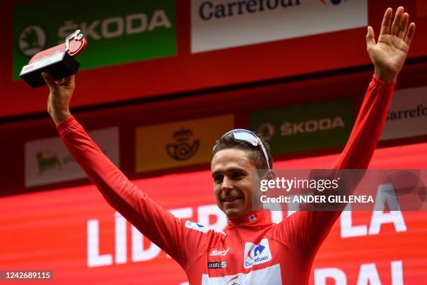 Team Groupama-FDJ's French rider Rudy Molard celebrates on the podium wearing the overall leader's red jersey after the 5th stage of the 2022 La...