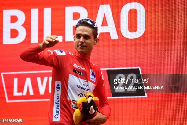 Team Groupama-FDJ's French rider Rudy Molard celebrates on the podium wearing the overall leader's red jersey after the 5th stage of the 2022 La...