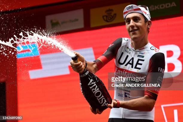 Team UAE Emirates' Spanish rider Marc Soler celebrates on the podium after crossing the finish line in first place during the 5th stage of the 2022...