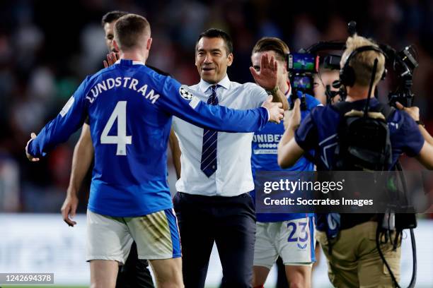 Coach Giovanni van Bronckhorst of Rangers FC celebrates the qualification for the Champions League with John Lundstram of Rangers FC during the UEFA...