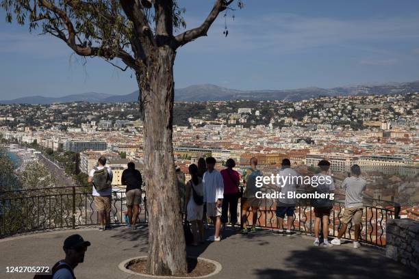 Tourists take photos from a terrace overlooking the skyline in Nice, France, on Wednesday, Aug. 24, 2022. French Finance Minister Bruno Le Maire said...