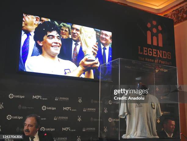Former German soccer player Lothar Matthaus sits behind the jersey Diego Maradona wore in the 1986 World Cup final during a ceremony at Argentina...