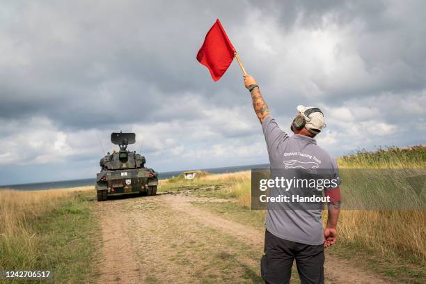 In this handout photo provided by the German Government Press Office , German Chancellor Olaf Scholz observes a training exercise with the...