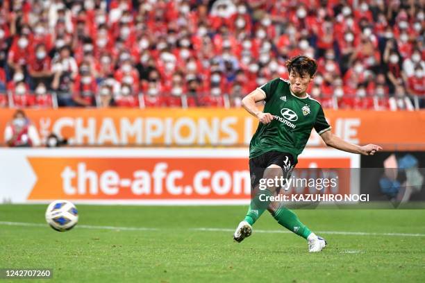 Jeonbuk's South Korean midfielder Kim Bo-kyung shoots during the penalty shootout at the end of the AFC Champions League semi-final football match...