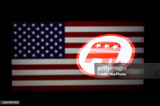 Republican Party logo displayed on a phone screen and American flag displayed on a laptop screen are seen in this multiple exposure illustration...