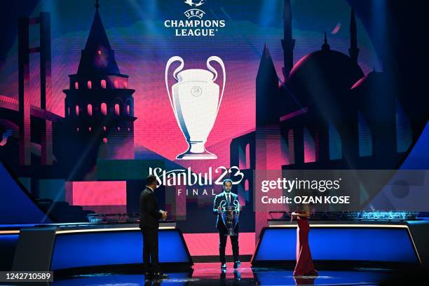 Champions League Final Ambassador for 2023 Former Turkish player Hamit Altintop holds the Champions League trophy on stage in Istanbul on August 25,...