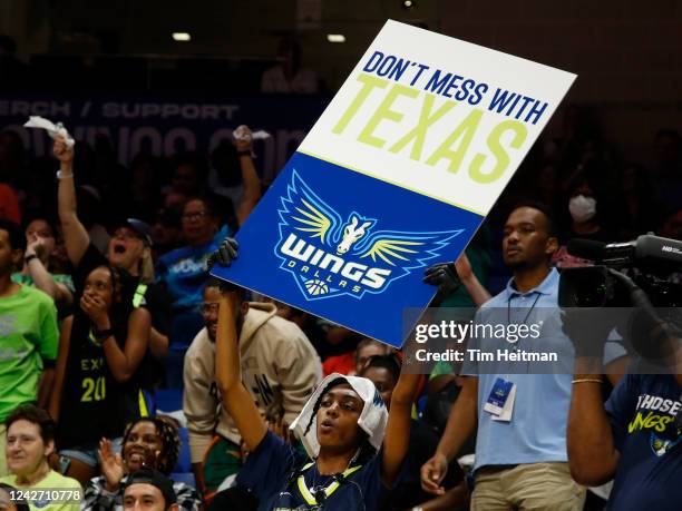 Fans hold a sign supporting the Dallas Wings during the game against the Connecticut Sun during Round 1 Game 3 of the 2022 WNBA Playoffs on August...