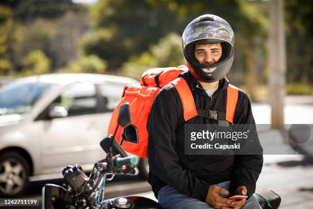 delivery guy portrait wearing helmet - motoboy - motoboy stock pictures, royalty-free photos & images