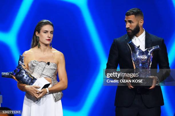 Barcelona's Spanish forward Alexia Putellas holds her women's best player of the year award next to Real Madrid's French forward Karim Benzema...