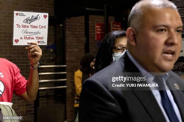 Person holds a sign reading 'Welcome to New York City!' as New York Immigrant Affairs Commissioner Manuel Castro speaks during a press conference...