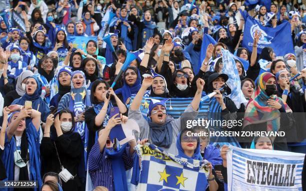 Iranian women fans of Esteghlal football club cheer during a match between Esteghlal and Mes Kerman at the Azadi stadium in the capital Tehran, on...