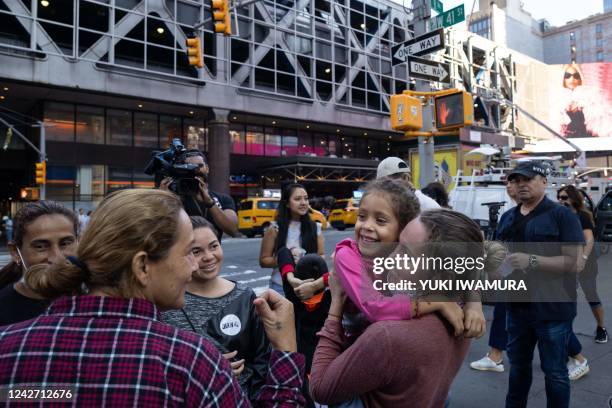 Members of the Borrero family, from Venezuela, stand outside Port Authority Bus Terminal in New York City on August 25 after arriving on a bus from...