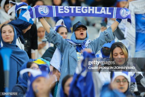 Iranian women fans of Esteghlal football club cheer during a match between Esteghlal and Mes Kerman at the Azadi stadium in the capital Tehran, on...