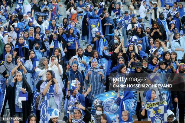 Iranian women fans of Esteghlal football club cheer during a match between Esteghlal and Mes Kerman at the Azadi stadium in the capital Tehran, on...