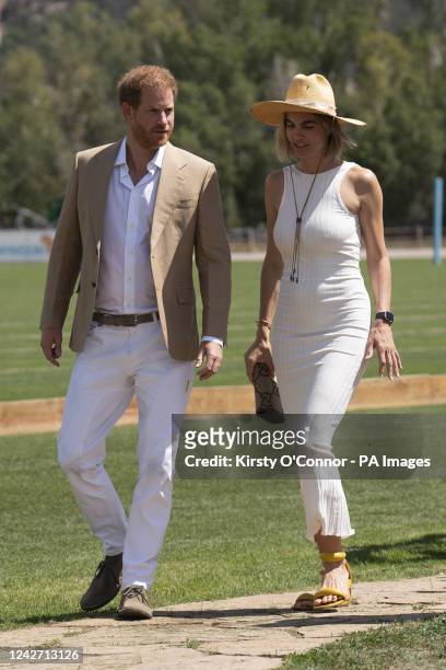 The Duke of Sussex walks with Delfina Blaquier as he arrives for a polo match during the Sentebale ISPS Handa Polo Cup at the Aspen Valley Polo Club...