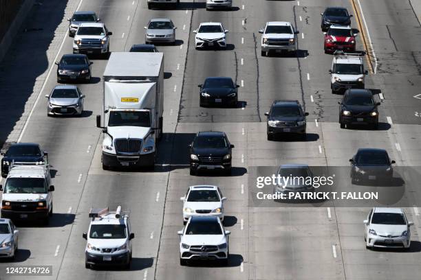 Cars, trucks, SUVs, and other vehicles drive in traffic on the 405 freeway through the Sepulveda Pass in Los Angeles, California, on August 25, 2022....