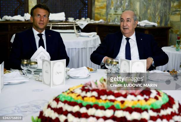 French President Emmanuel Macron attends a banquet hosted by Algeria's President Abdelmadjid Tebboune at the presidential palace in Algiers on August...