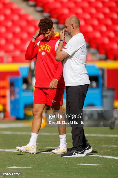 Patrick Mahomes of the Kansas City Chiefs listens to Chiefs quarterback coach Matt Nagy prior to the preseason game against the Green Bay Packers at...