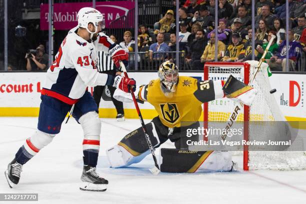 Golden Knights goaltender Logan Thompson makes a save against Washington Capitals right wing Tom Wilson in the second period during an NHL hockey...