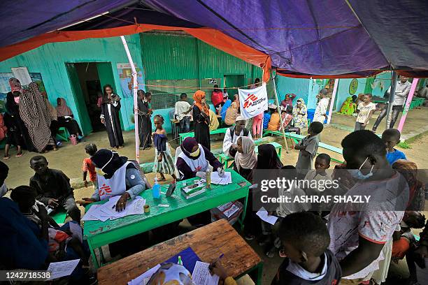 People who fled ethnic clashes in Sudan's Blue Nile state wait at a clinic set up by health authorities in collaboration with Medecins Sans...