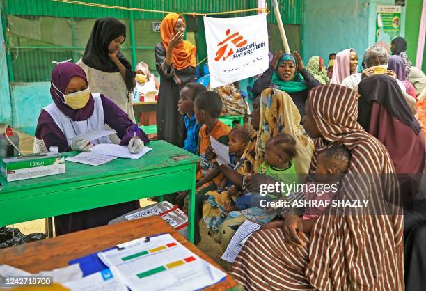 People who fled ethnic clashes in Sudan's Blue Nile state wait at a clinic set up by health authorities in collaboration with Medecins Sans...