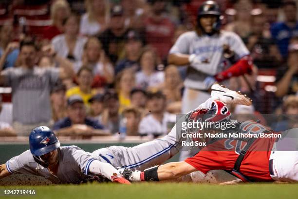 Cavan Biggio of the Toronto Blue Jays slides to score the go-ahead run during the tenth inning of a game against the Boston Red Sox on August 25,...