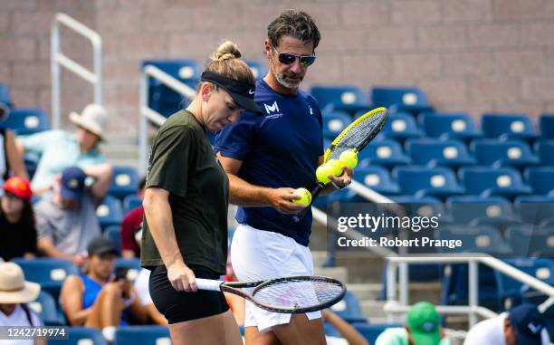 Simona Halep of Romania with coach Patrick Mouratoglou during practice ahead of the US Open Tennis Championships at USTA Billie Jean King National...