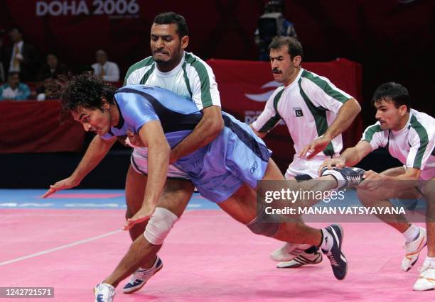 Pakistan's Wasim Sajjad , Badshah Gul and Nasir Ali try to catch India' s Manpreet Singh during the men's kabaddi gold final match at the 15th Asian...