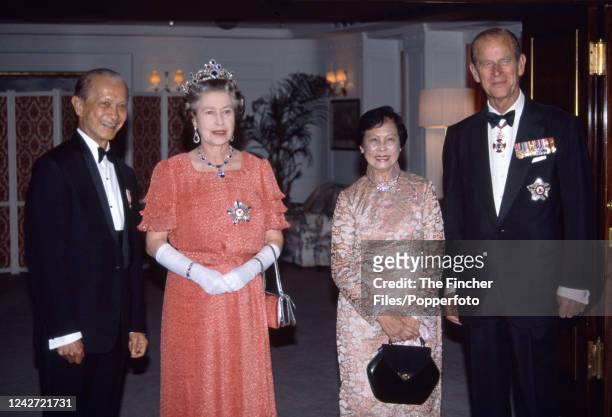 Queen Elizabeth II and Prince Philip with the President of Singapore Wee Kim Wee and his wife Koh Sok Hiong aboard The Royal Yacht Britannia for a...