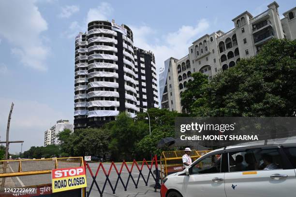 Police barricades cordon off a road near the 100-meter-high residential twin tower which is slated for demolition by controlled implosion on August...