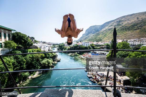 In this handout image provided by Red Bull, Jonathan Paredes of Mexico dives from the 21 metre Stari Most during the first competition day of the...