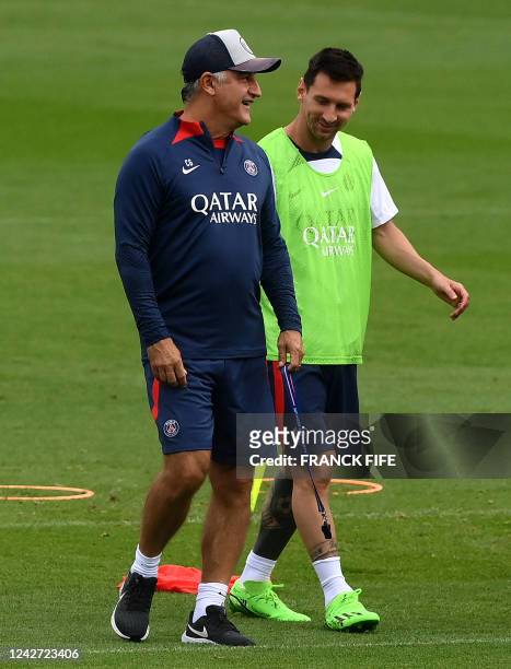 Paris Saint-Germain's French head coach Christophe Galtier speaks with Paris Saint-Germain's Argentinian forward Lionel Messi during a training...