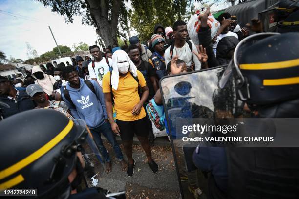 Migrants protest as the French National Police evacuate migrants from a squat in the city of Toulouse, southwestern France, on August 26, 2022.