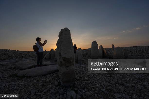 Tourists visit the Dolmen of Guadalperal megalithic site as it is now fully emerged after waters in the surrounding Valdecanas reservoir receded due...