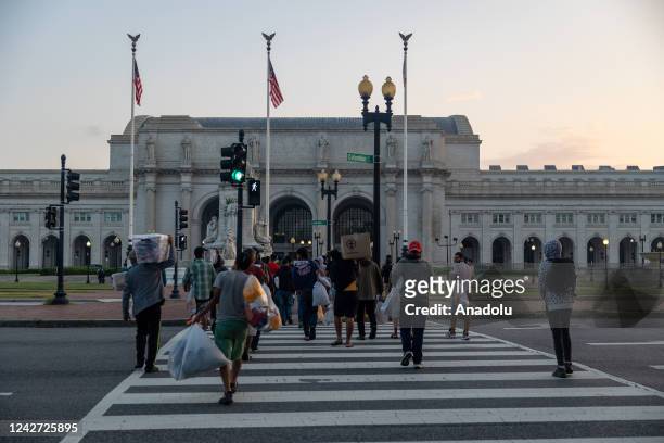 Immigrants walk towards Union Station after arriving in Washington, DC, United States on the morning of August 26th, 2022 after being bussed across...