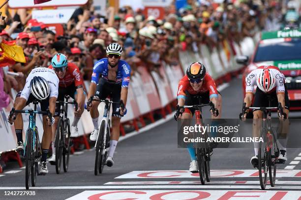 Team Cofidis' Spanish rider Jesus Herrada crosses the finish line in first place followed by Team Astana's Italian rider Samuele Battistella and Team...