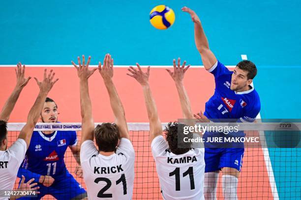 Frances Trevor Clevenot spikes the ball against Germanys Moritz Reichert , Tobias Krick and Lukas Kampa during the World Volleyball Championship Pool...