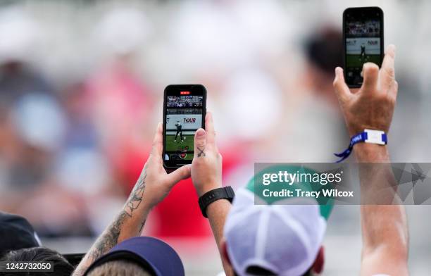 Fans take photos with their iPhone on the first tee during the second round of the TOUR Championship at East Lake Golf Club on August 26, 2022 in...