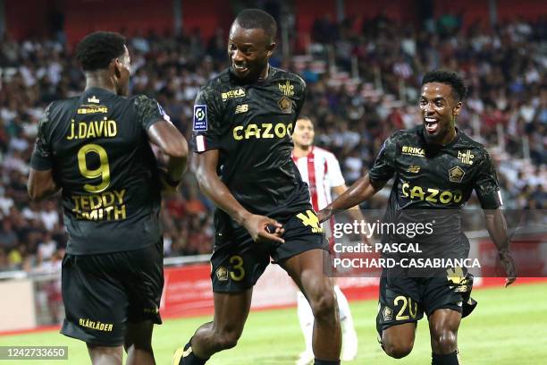 Lille's defender Tiago Emmanuel Embalo Djalo is congratulated by teammates after scoring a third goal for his team during the French L1 football...