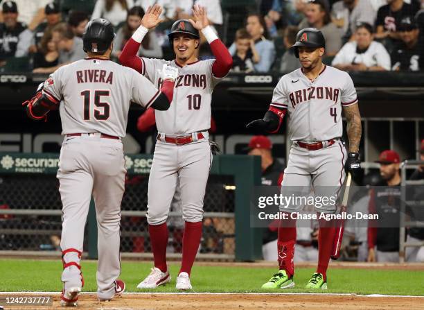 Emmanuel Rivera of the Arizona Diamondbacks is congratulated by Josh Rojas of the Arizona Diamondbacks and Ketel Marte of the Arizona Diamondbacks...