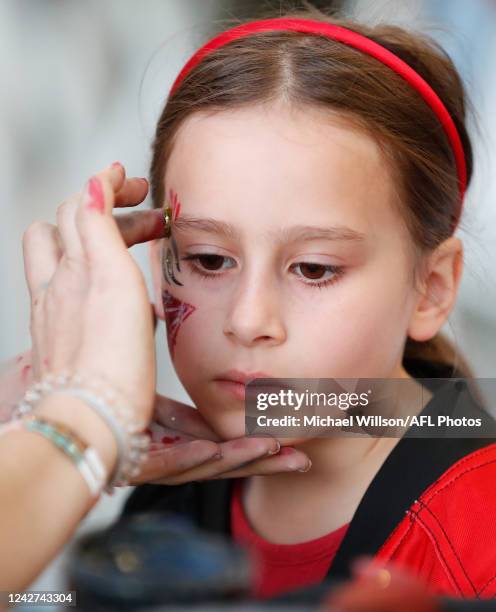 Bombers fan has her face painted during the 2022 S7 AFLW Round 01 match between the Essendon Bombers and the Hawthorn Hawks at Marvel Stadium on...