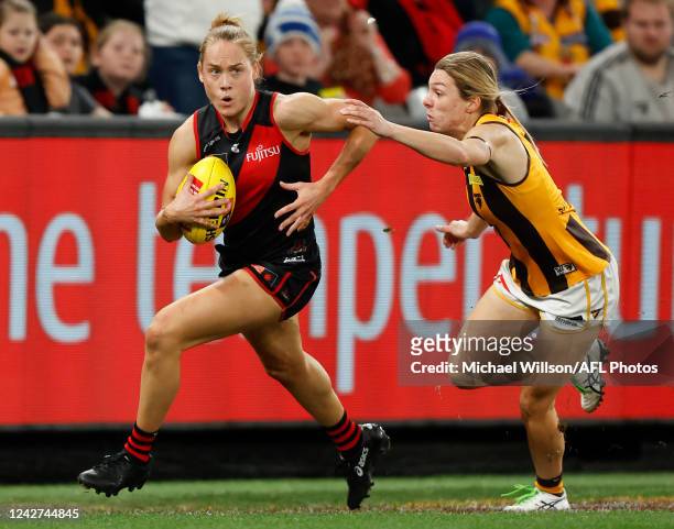 Stephanie Cain of the Bombers is chased by Tahlia Fellows of the Hawks during the 2022 S7 AFLW Round 01 match between the Essendon Bombers and the...